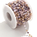 Colorful faceted crystal bead chain in mixed pink and gold on a white spool roll - Steel-Dark Brown Multi