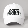 Close-up of God's Favorite bold black embroidery on a white cotton baseball cap - Adjustable / White
