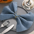 Detail of moon and star enamel napkin ring in navy and gold on a blue linen napkin - Navy Blue Enamel Moon