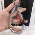 Handheld silver rhinestone phone chain featuring a sparkling red heart gemstone charm - Red Rhinestone Heart Charm