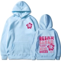 Detail of light blue hoodie featuring pink hibiscus print and retro Ocean Beach back graphic - S / Light Blue
