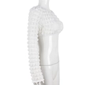 Detail of white long sleeve crop top featuring 3D popcorn texture and cutout neckline - S / White