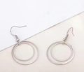 Detail view of double-layered silver metal hoop earrings on a clean background - Silver