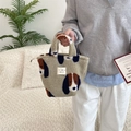Detailed close-up of plush fleece handbag with colorful dog patterns and top zip closure - Camel Dog Pattern