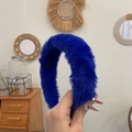 Detail of hand holding a soft blue plush headband featuring classic minimalist design - Royal Blue
