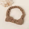 Detail of coffee brown cotton baby headband with bow and elastic band texture - Brown