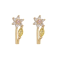 Detailed view of floral stud earrings with white petals and pink center stone - Gold Pink Flower Yellow Leaf