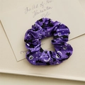 Macro detail of purple Halloween scrunchie featuring skull, bat and star patterns - Purple