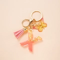 Pink glitter letter K keychain with butterfly charm and matching tassel on gold ring - Letter X