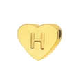 Macro detail of a heart-shaped golden bead with H engraving and side hole for jewelry DIY - Letter H
