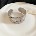 Detailed macro view of the silver open bangle with artistic hammered lava texture - Irregular Hammered Wide Open Bangle (GHB3991-2)