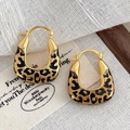 Detailed shot of golden U-shaped earrings with black leopard print enamel finish - 13# Hoop Earrings - Enamel Square