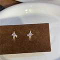 Macro shot of gold cross star earrings featuring purple heart zircon stones and white crystals - Gold Four-pointed Star / Earring Posts