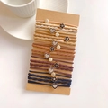 Detail of multi-color elastic hair ties with alloy charms on brown card packaging - Flower Heart Combination Set