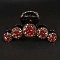 Black hair claw clip with five circular red and champagne rhinestone floral accents - Amber Red