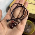 Macro detail of polished rosewood gourd pendant with black woven cord and red accent bead - Neck-Hanging Style / Extra Small (1.7x1.7x3cm) / Rosewood Color