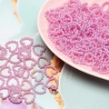 Close-up of pink heart-shaped ABS pearl beads for DIY crafts and nail art decoration - Purple