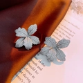 Macro view of flower-shaped stud earrings with micro-pave crystals on silver metal - 5# Silver Flower