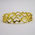 Detailed view of polished golden hollow heart napkin ring for elegant table setting - Gold
