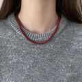 Close-up of vibrant red beaded necklace worn over a grey knit sweater for a chic look - 4mm / Red