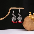 Detailed close-up of peacock-style drop earrings with red beads on a branch - E4699 Red Peacock Tassel