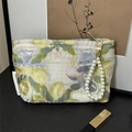 Floral brocade makeup bag with pearl handle and golden clasp for portable storage - Lemon