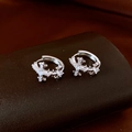 Macro view of silver drop earrings with cross design and sparkling cubic zirconia stones - Cross Micro-pave Zircon Ear Buckle