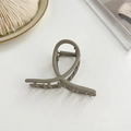 Greyish green matte metal hair claw clip with twisted loop design on white background - Light Green