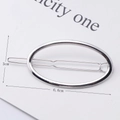 Minimalist silver oval metal hair clip showing 6.6cm length dimension on white card - Silver Oval