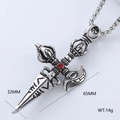 Macro detail of a vintage stainless steel vajra pendant necklace with a red center stone - Vajra Pestle Ritual Tool Style (Style 13)