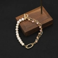 Elegant pearl bracelet with pink faceted beads and gold toggle clasp on wood - Asymmetric Oval Pendant Freshwater Pearl Bracelet