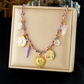 Colorful rope necklace with gold moon, heart, and Good Luck charms on a display pad - Moon Sun Horn GoodLuck Disc Pendant Style (N3700)