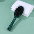 Dark green anti-static hair brush with gold ring accent and scalp massaging tips - Green Oval