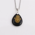 Detail of black teardrop pendant with golden Hamsa Hand on a silver rope chain - Black Stone with 60CM Rope Chain
