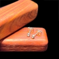 Macro detail of minimalist silver screw-back stud earrings with zircon inlay on wood - 3mm Stud Style (Single) / Steel