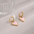 Golden heart earrings with pink marbled enamel drops on a textured glass backdrop - Heart Enamel / Gold Pink