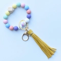 Detail of leopard silicone beads, wooden bead, yellow leather tassel and gold keychain - Colorful