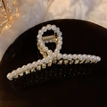 Elegant gold metal hair claw clip featuring a circular pattern of white pearls - Pearl Cross-Bar