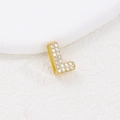 Macro shot of gold letter L pendant with cubic zirconia inlay and sparkling stones - L (Single Pendant)