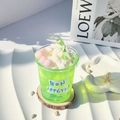 Detail of green jelly candle with cream topping and pink heart on wood base - Heart Green Grape