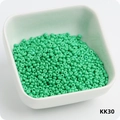 Vibrant mint green 3mm glass seed beads in a white bowl for DIY bracelet making - KK30 Pine Green