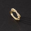 Macro detail of gold-plated layered ring with sparkling zircon and pavé diamonds - Intertwined Double Layer Rhinestone Style
