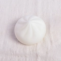 White squishy steamed bun toy with realistic spiral texture on a soft fabric background - 6cm Sharp Bun Squishy
