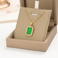 Detailed macro view of an emerald green gemstone necklace pendant in a gift box - Gold Green