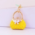 Portachiavi a borsa gialla con strass, fiocco bianco e finiture a catena oro - Giallo