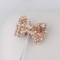 Macro shot of champagne crystal bow pendant with sparkling rhinestones for DIY jewelry - Champagne AB