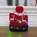Knitted Christmas hat with reindeer pattern and colorful LED lights on wooden table - Red Black Reindeer