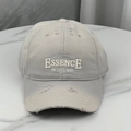 Detail of distressed beige baseball cap featuring white embroidery and vintage torn brim - One Size (54-60cm) / Gray