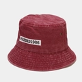 Detailed macro view of vintage burgundy washed cotton bucket hat with white embroidery patch - M (56-58cm) / Burgundy