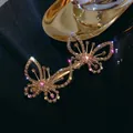 Barrette papillon dorée avec strass blancs étincelants pour une coiffure élégante - Doré